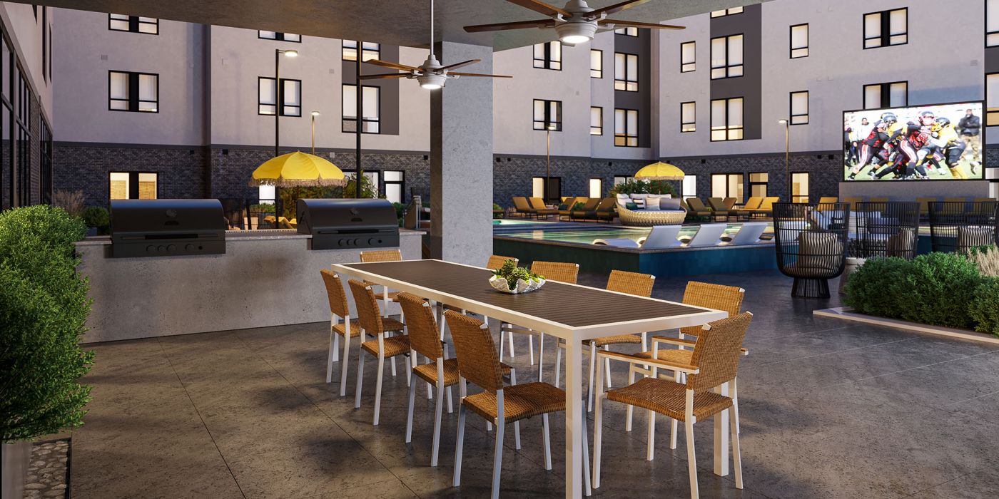 Outdoor lounge with large tv, grilling area, and pool