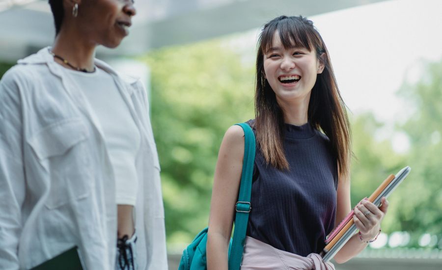 Two college students laughing together as they explore West Lafayette