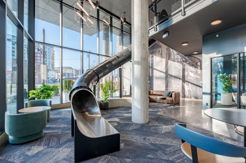 interior of community center at verve west lafayette with couches and slide