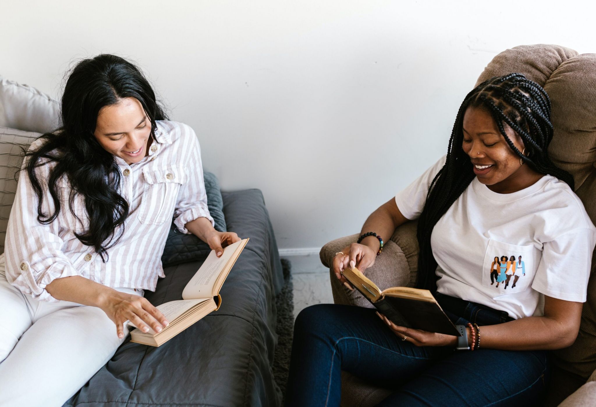 two people sitting and reading books